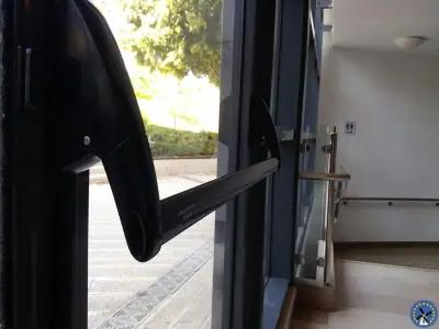ידית בהלה על דלת זכוכית חיצונית של מבנה ליציאת חירום בטוחה